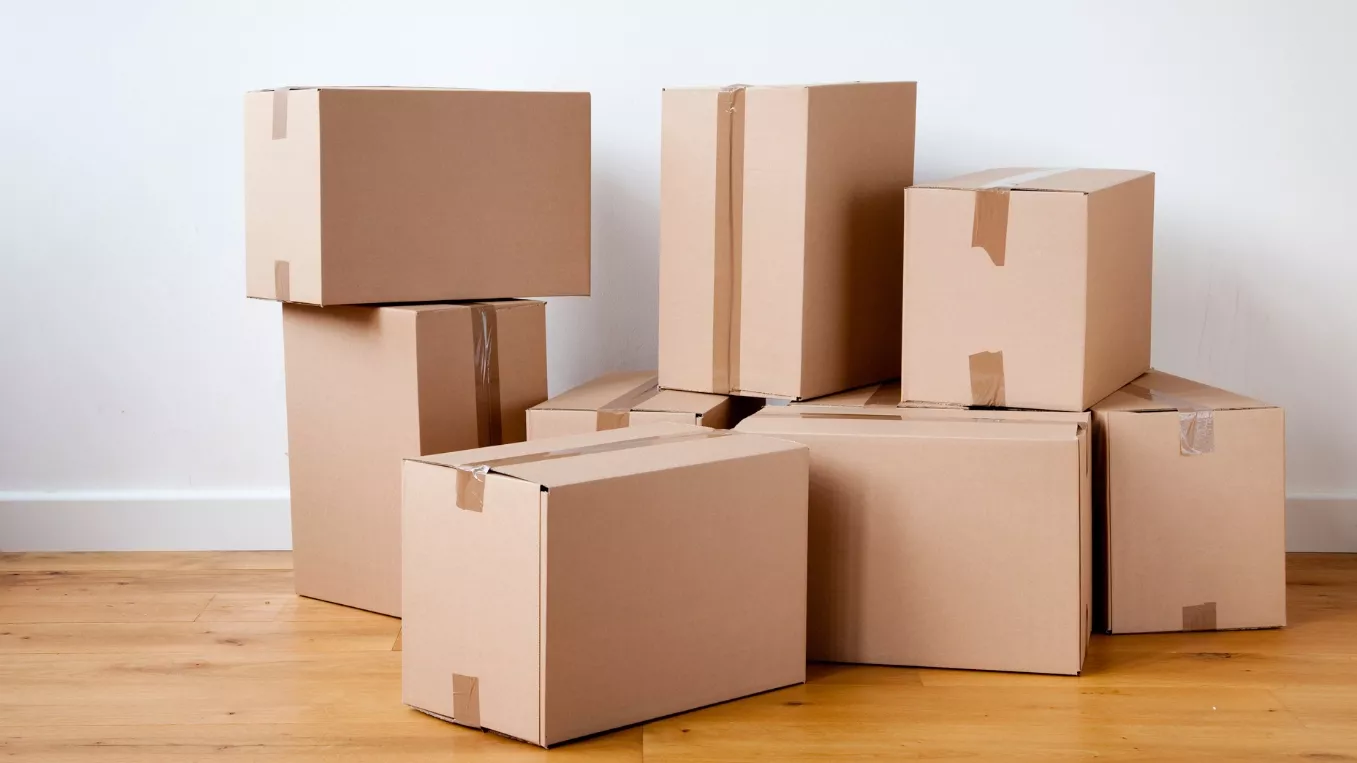 Multiple moving boxes on a wooden floor